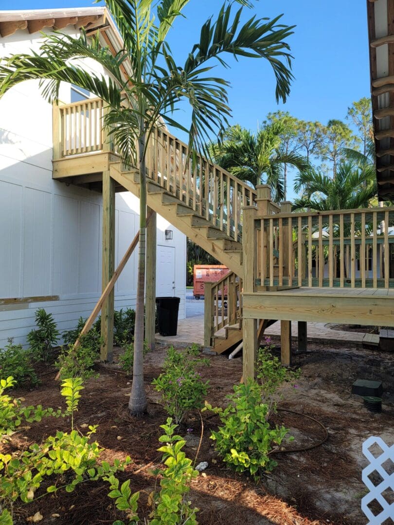 A wooden staircase going up to the top of steps.