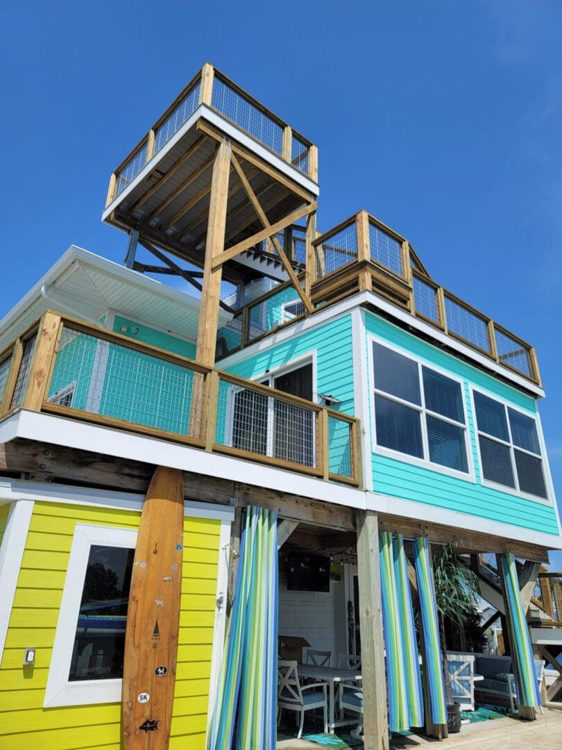 A house with a balcony and a deck on top of it.