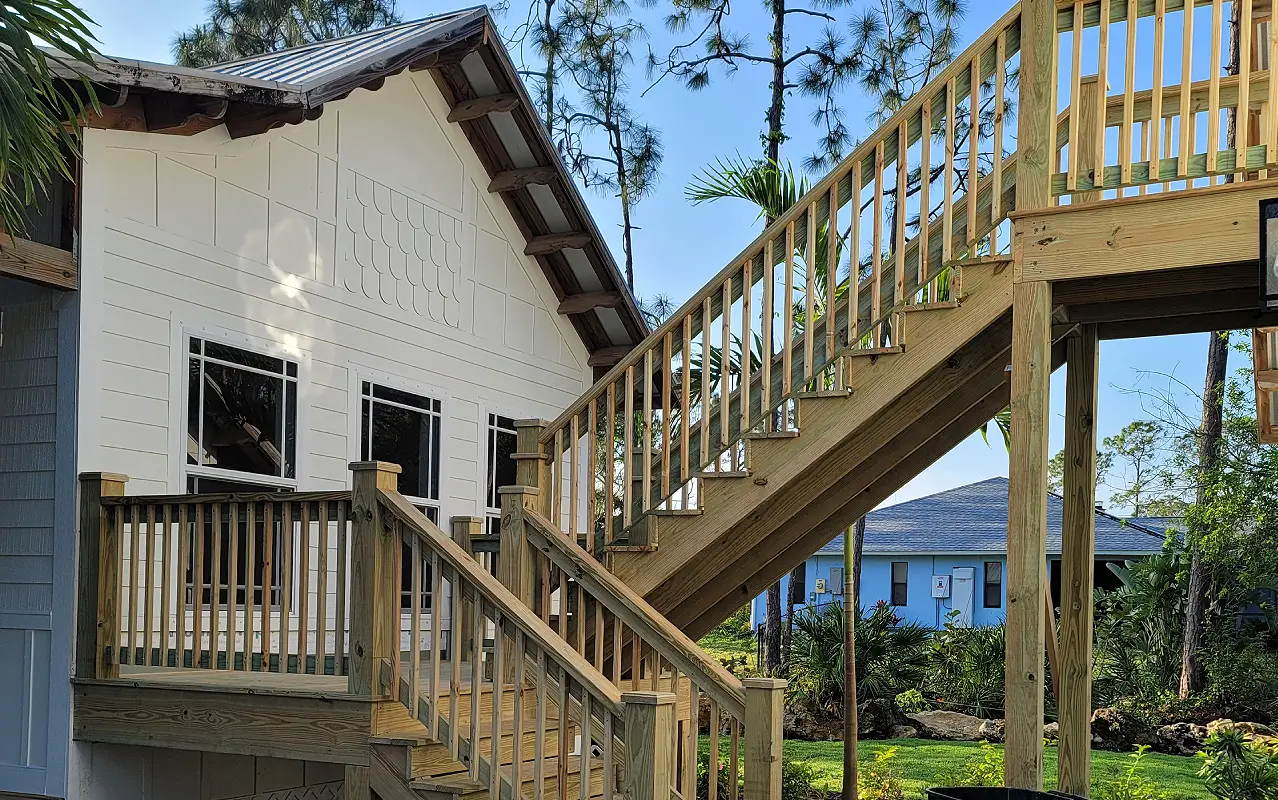 A house with stairs going up to the top of it.