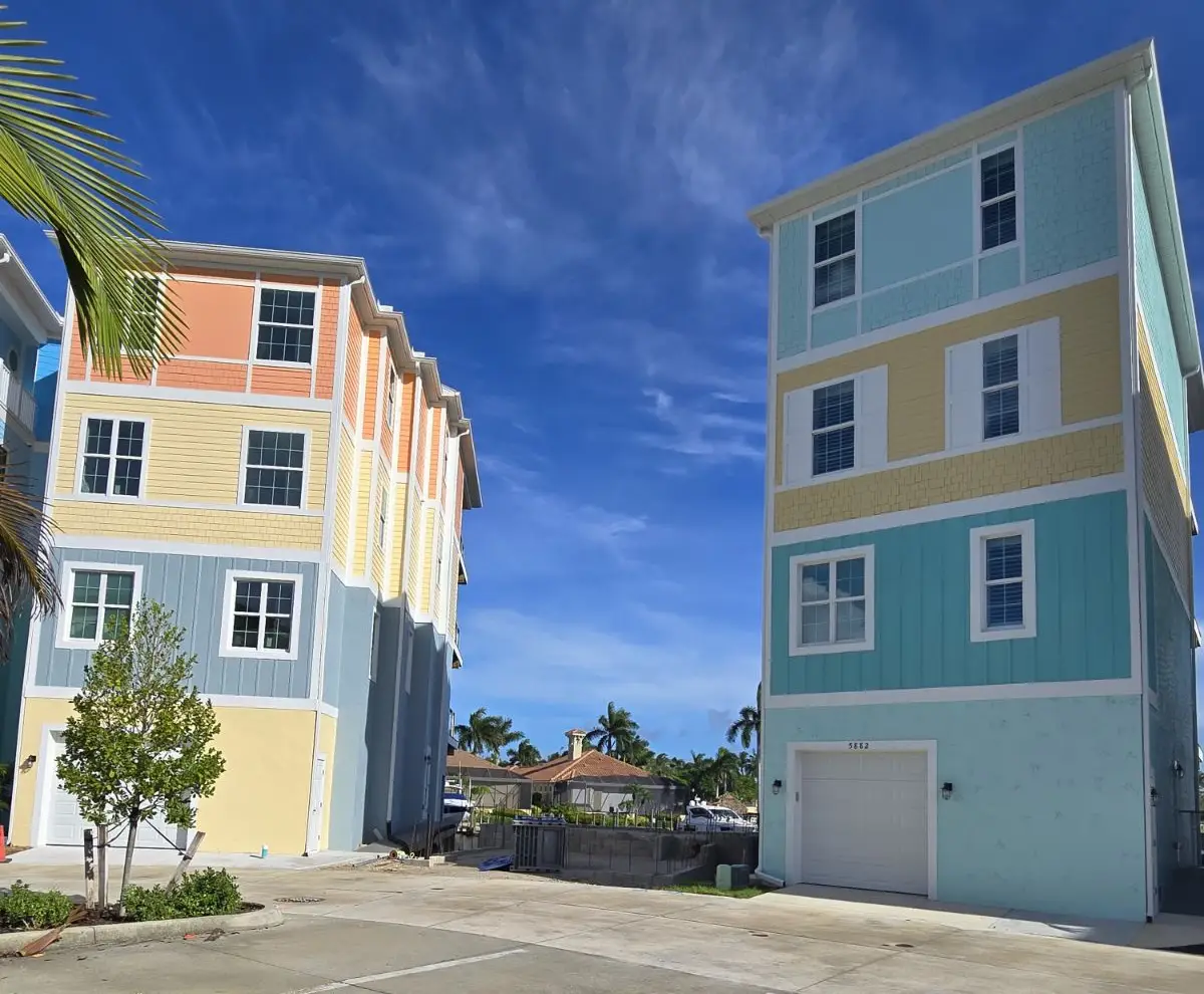 Two identical buildings are shown in a parking lot.