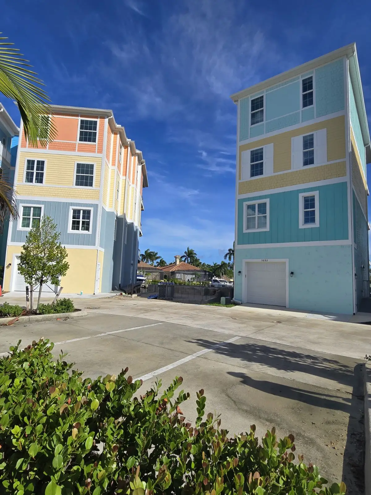 A parking lot with two buildings in the background.