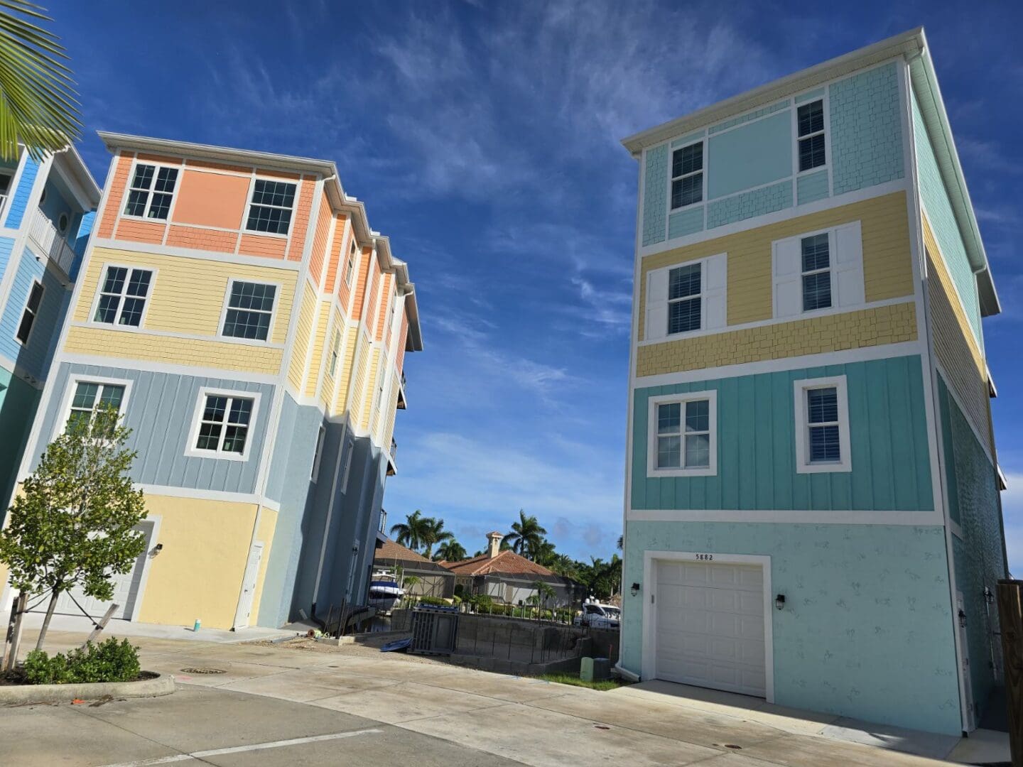 Two identical buildings are shown in a parking lot.